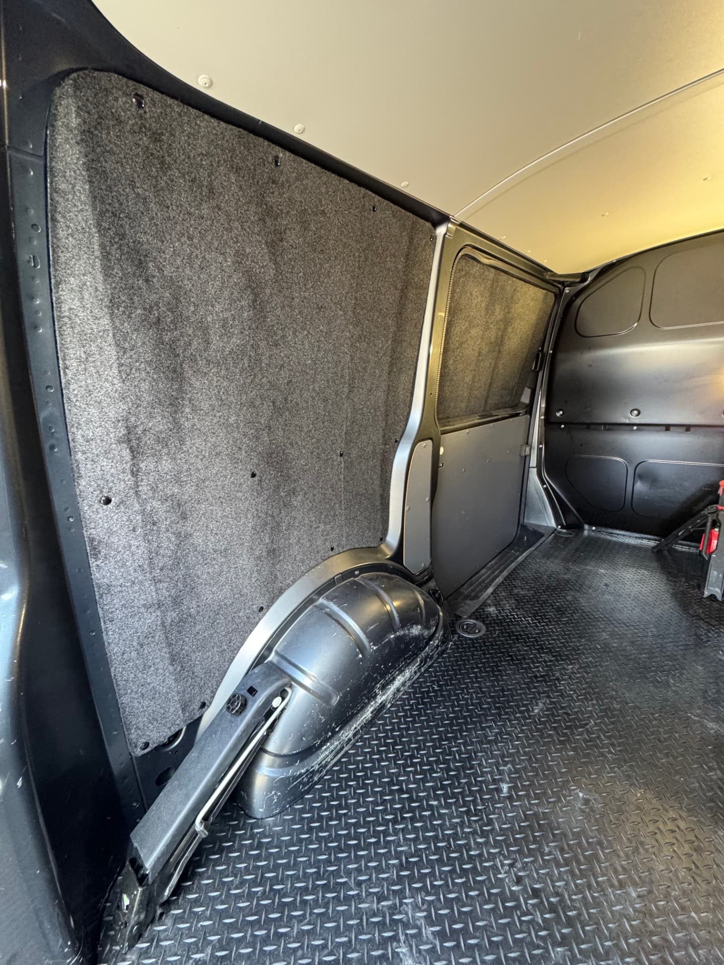 Grey carpet lined van load area with a clean professional finish